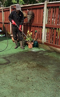 man cleaning a garden after drain spillage - Lancashire Septic Tank And Drainage Specialists 